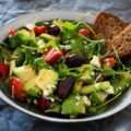 Delicious Greek salad featuring avocado, feta, and olives, ideal for a healthy meal.